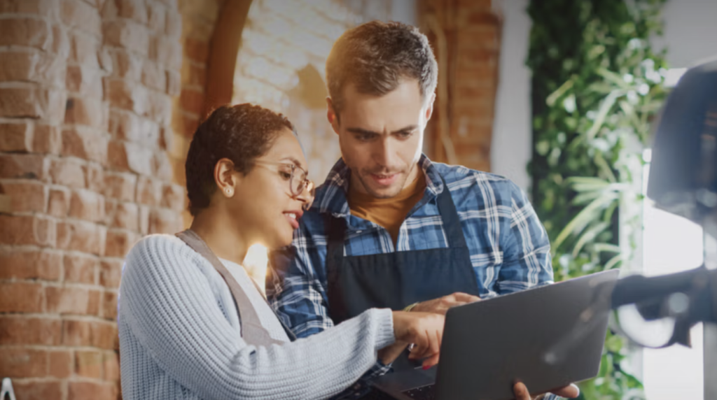 a woman and a man looking at franchise options
